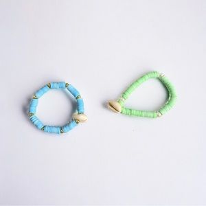 Two. Bracelets with shell charms.